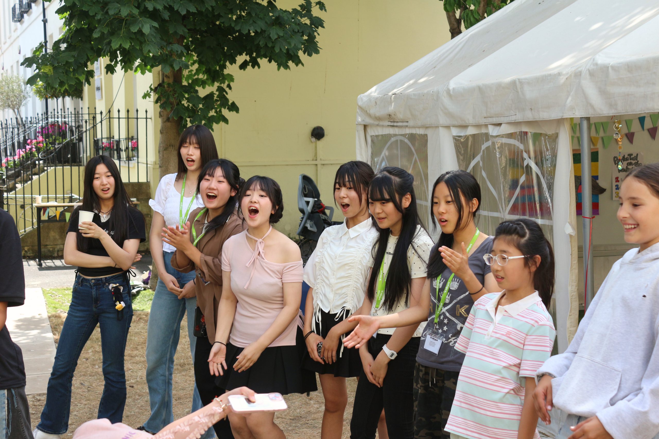 Summer camp students playing football together on a sports afternoon