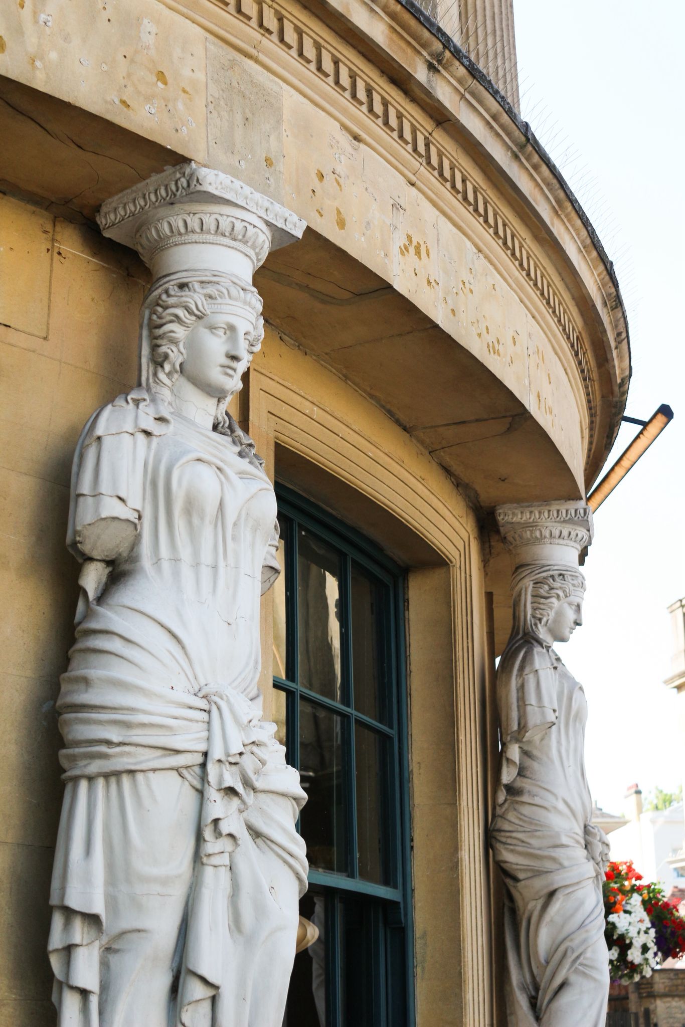 A Regency terrace in Cheltenham with cream stucco facades and wrought-iron balconies